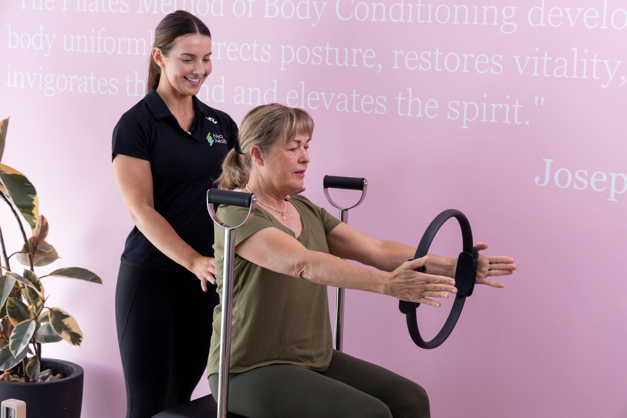 physio treating client with chronic pain with reformer pilates treatment