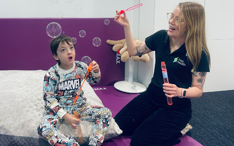 OT blowing bubbles with child